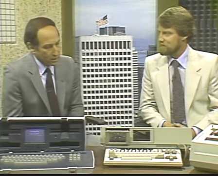 Stewart Cheifet and Gary Kildall on the set of “Computer Chronicles.” On the desk in front of them are an Osborne-1 computer and a Coleco ADAM computer.