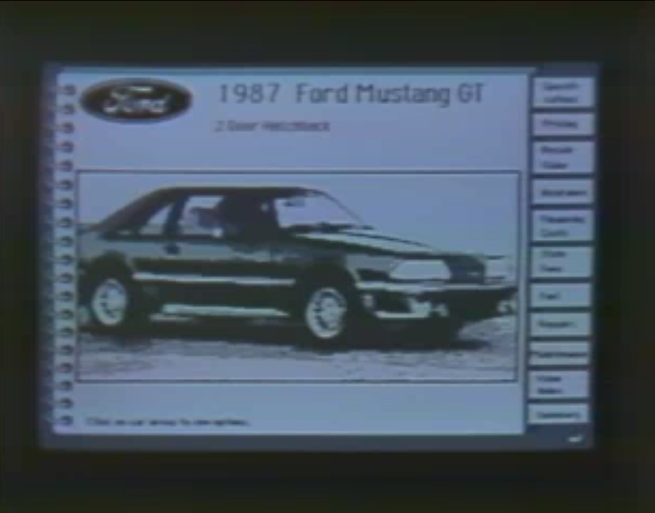 A screenshot from &ldquo;The Complete Car Cost Guide&rdquo; for HyperCard. There is an image of a 1987 Ford Mustang GT that covers most of the screen. To the right are a series of buttons.
