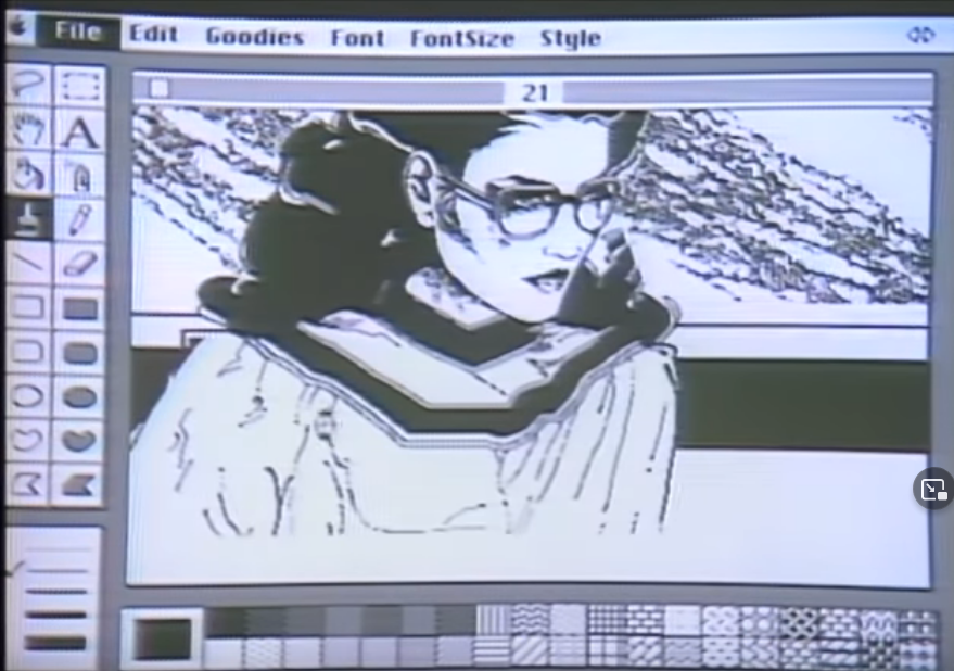 A piece of clip art displayed in “MacPaint” for the Macintosh 512K. The clip art is a black-and-white illustration of a white woman in three-quarter profile with long, dark curly hair and eyeglasses.