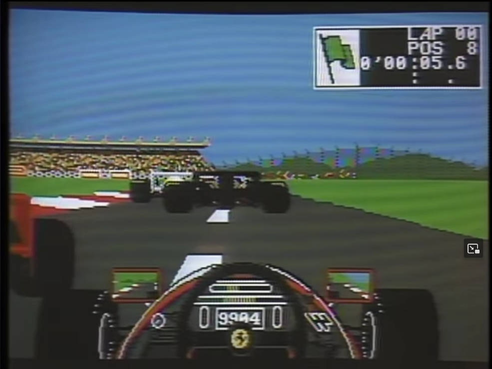 A screenshot from the demonstration of “Ferrari Formula One” on “Computer Chronicles.” The screen shows a first-person view of a driver in the middle of a race. On the top left is a box with the lap number, the player’s current race position, and the time of the current lap.