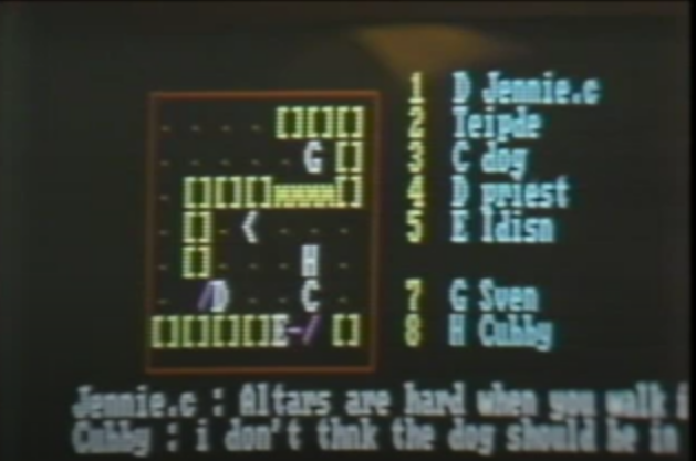 A screen capture showing &ldquo;Island of Kesmai.&rdquo; The screen shows a 7-by-7 grid representing a room in a dungeon. To the right is a list of player command options. On the bottom is text representing player chat.