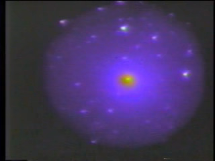 A Doppler image of Halley’s Comet. The image is of a large blue-colored sphere with a smaller sphere, reddish-orange in color, at the center.