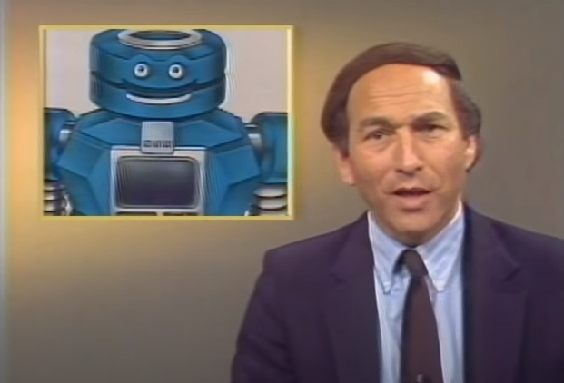 Stewart Cheifet presenting “Random  Access” with an insert image of a large blue robot with a human-like face.