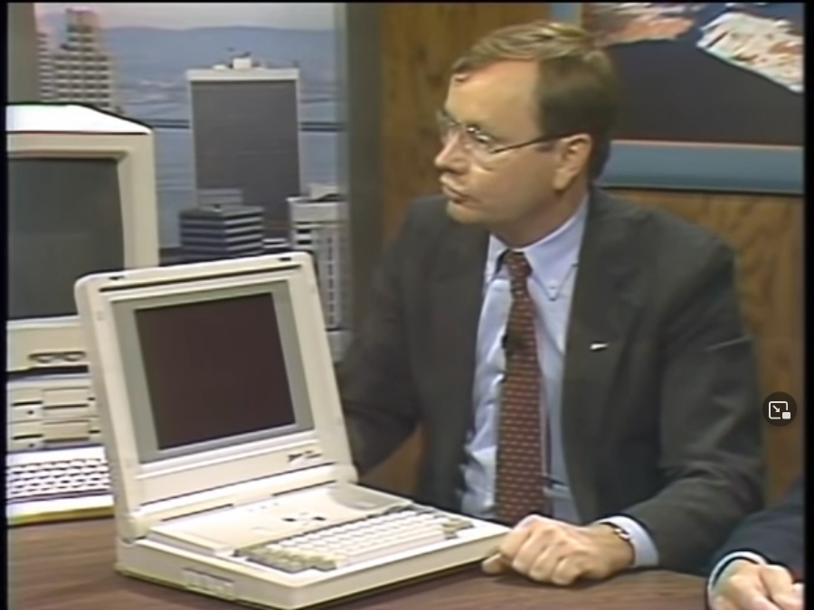Andrew Czernek on the set of “Computer Chronicles.” On the desk in front of him is a white Z-181 portable computer. The machine’s screen is flipped open.